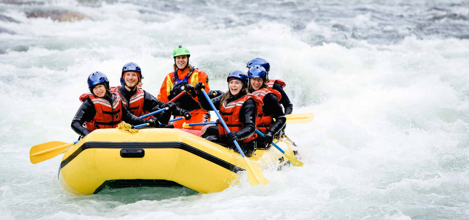 Adventure tourism training students in a yellow white water raft
